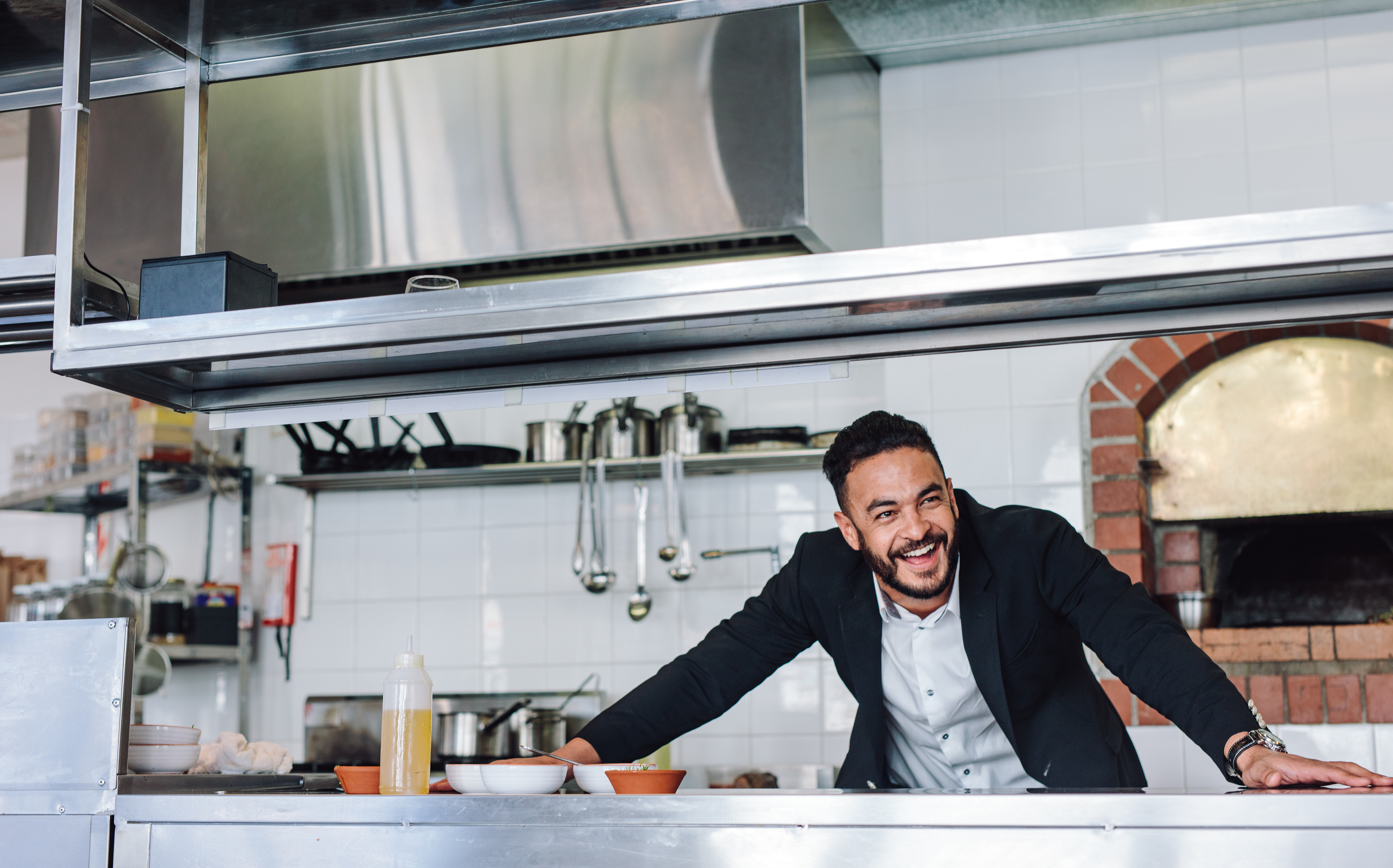 Man smiling behind counter