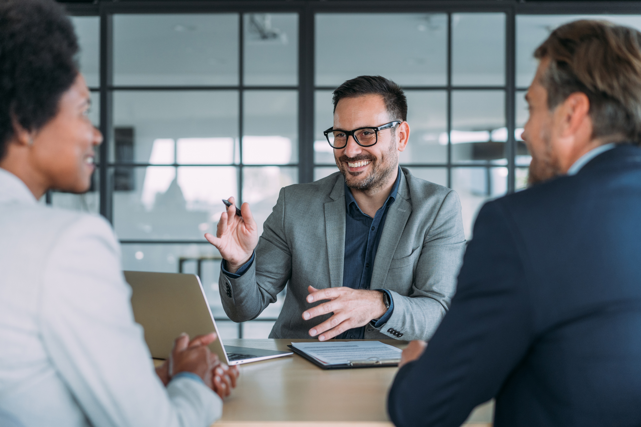 Business man explaining insurance to people
