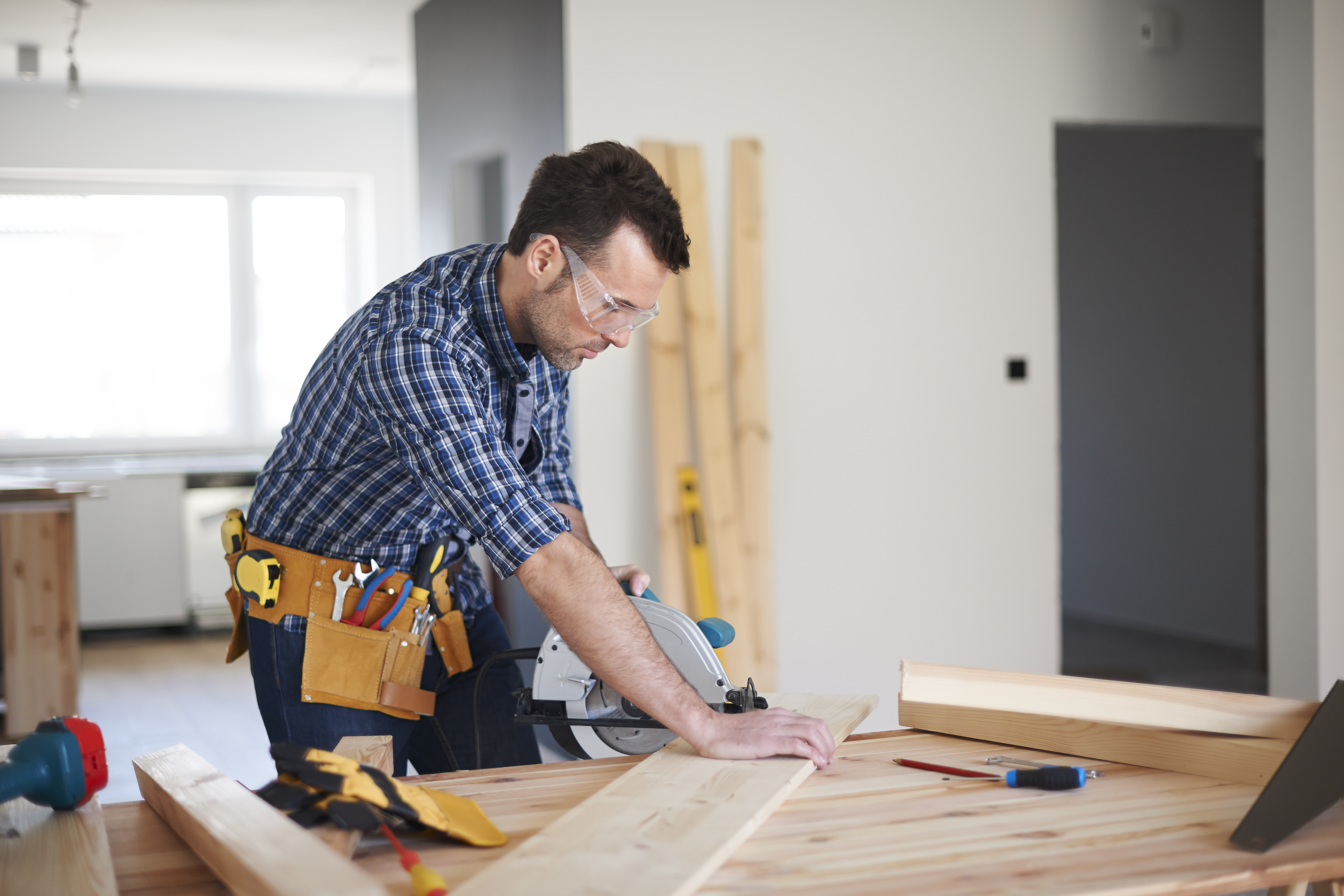 Man using circular saw to cut wood